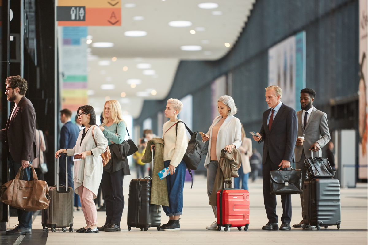 Group of people in line in the airport with their luggage